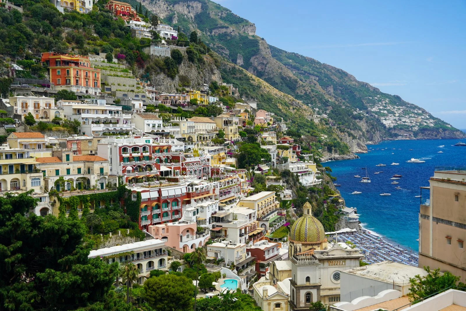 Cliffside buildings and boats along the coast of Positano, Italy.